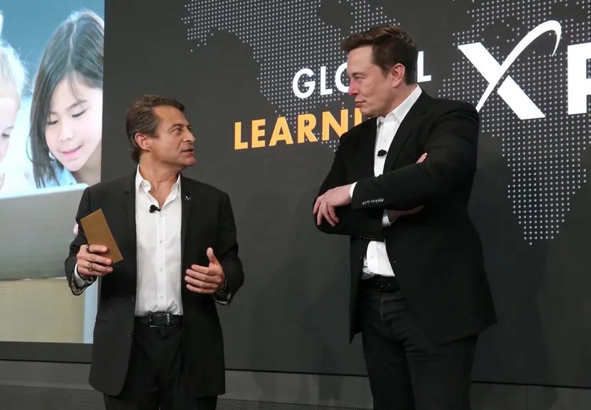 Elon Musk on stage in front of the Global Learning XPRIZE logo