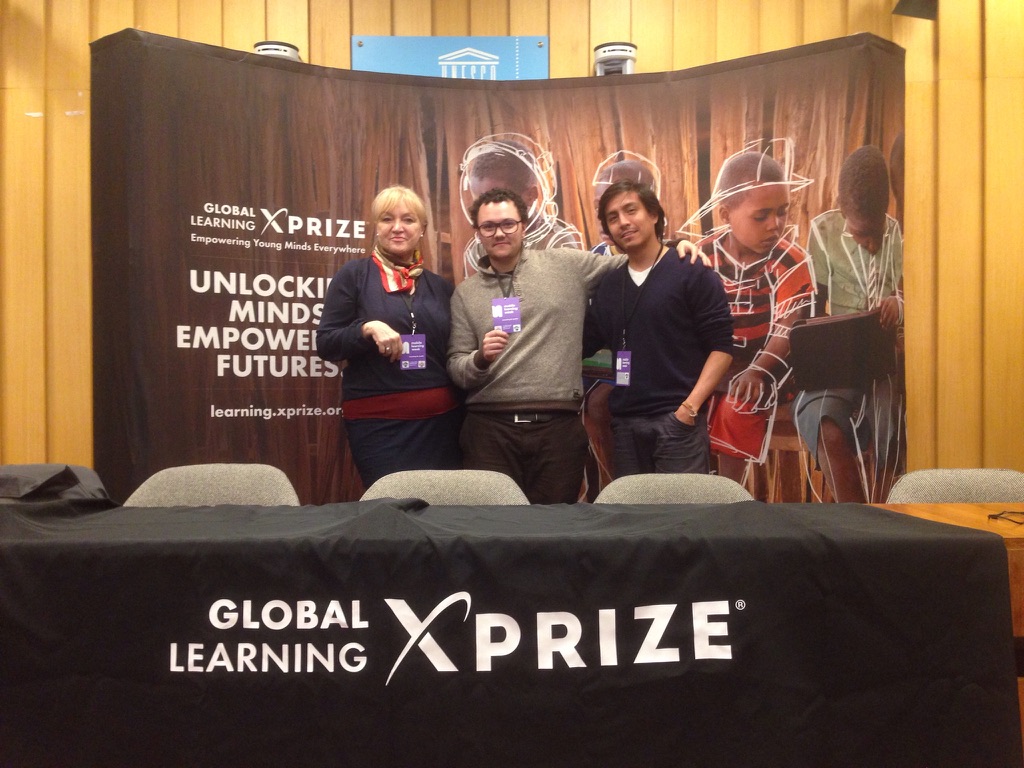 Riley's team standing at the Global Learning XPRIZE stand at UNESCO